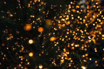 Golden blurred Christmas, New Year decorations of twinkling gold light, festive background for winter holiday design