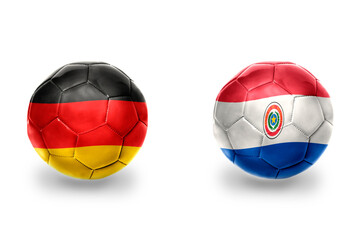 Fototapeta premium football balls with national flags of germany and paraguay ,soccer teams. on the white background.