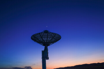 Astronomical telescope equipment, silhouette at sunset