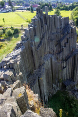 Majestic basalt mountains from which trees grow. Rod-shaped hexagonal stone mountains in the...