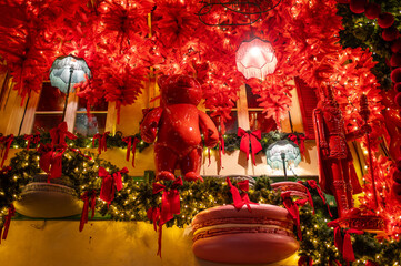 Christmas installation consisting of houses decorated with a macarons, luminous garland, Christmas trees toy birds,lanterns and animals. Vilnius, Lithuania.