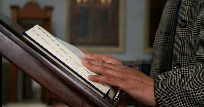 Priest leads sermon while reading sacred text, delivering a powerful gospel message to inspire faith and devotion. Scene embodies Christianity, orthodoxy, and the deep connection to spirituality.