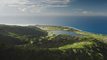 Breathtaking aerial view Moorea island in French Polynesia, green mountains forest, small village,...