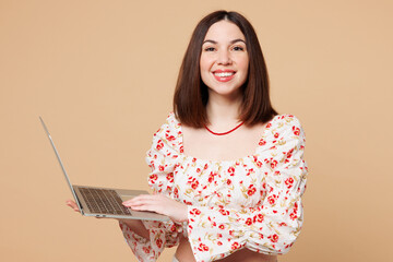 Young happy smiling IT woman wears white top casual clothes hold use work on laptop pc computer...