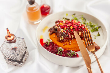 Duck Confit with Carrot Cream, Cranberry Sauce, and Hazelnut Praline
