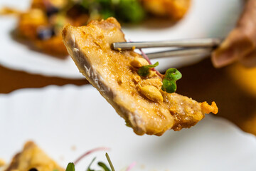fried pork slice with chopsticks