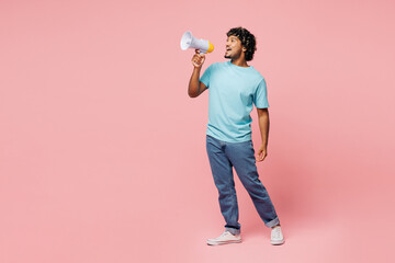 Full body young Indian man he wear blue t-shirt casual clothes hold in hand megaphone scream...