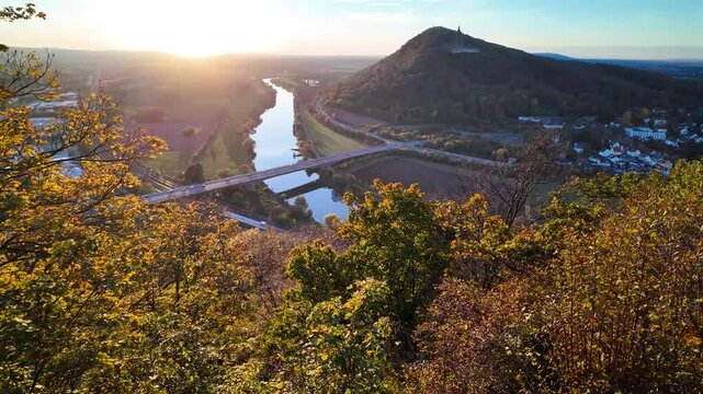 View from the Porta-Kanzel reveals the Kaiser Wilhelm Monument at Porta Westfalica, perched on a hill above the winding Weser River.