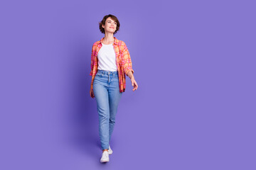 Full body portrait of pretty young lady walk empty space wear shirt isolated on purple color background