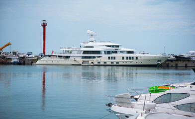 Yacht club and marina long view. Luxurious yacht marina. Yacht parking in harbor, harbor yacht club Beautiful Yachts in blue sky background.