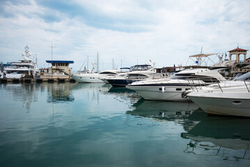 Yacht club and marina long view. Luxurious yacht marina. Yacht parking in harbor, harbor yacht club Beautiful Yachts in blue sky background.