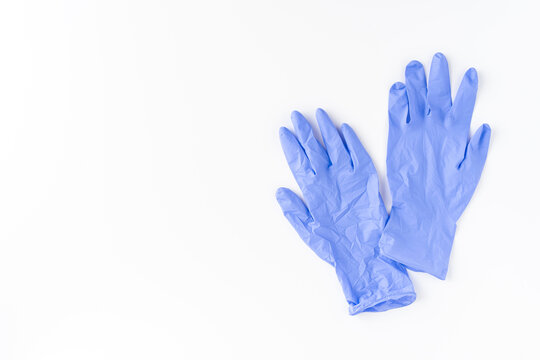 Blue latex gloves on white background. Top view