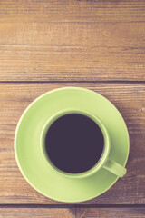 Coffee cup on yellow wooden table