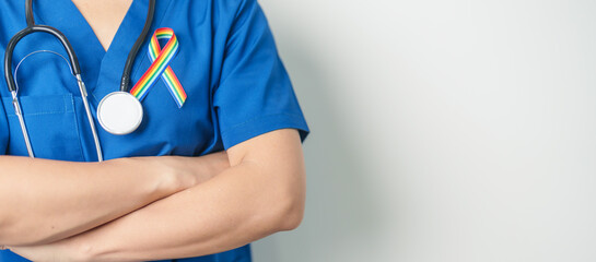 Doctor with LGBTQ Rainbow ribbon for Support Lesbian, Gay, Bisexual, Transgender and Queer community and happy Pride month concept