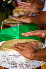 Obraz premium Several atabaque drums decorated with fabric being used during an Umbanda religious ceremony in Brazil.
