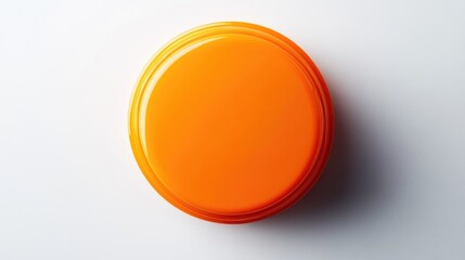 Bright orange cosmetic container viewed from above, featuring a smooth, glossy surface and a round shape, emphasizing its simplicity and vibrant color.