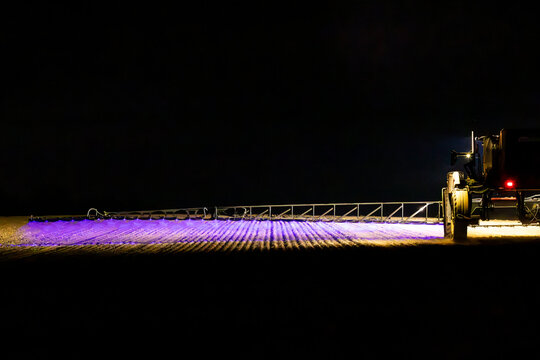 Self propelled boom sprayer spraying herbicide after planting canola