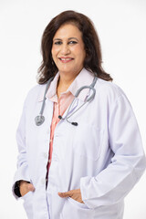 Fototapeta premium Portrait of smiling confident senior female doctor wearing lab coat standing against white background