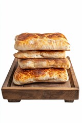 Four toasted flatbreads stacked on wooden tray.