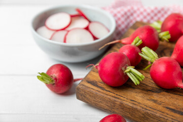 Fresh radish on textured wooden background. Organic natural garden radish slices. clipping root crop. Vegetables. Vegan. Diet products. Healthy food. Place for text. Copy space.