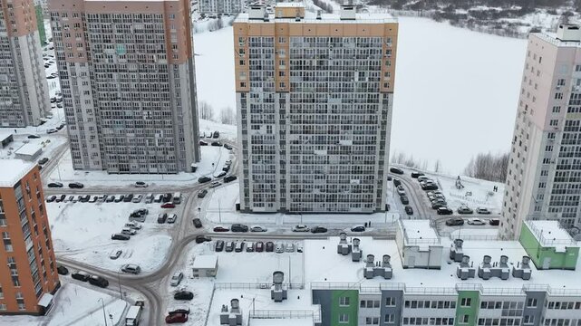 Large apartment building with many windows and balconies. The building is empty and has a very cold and desolate feel to it