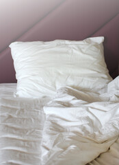 Bed white pillows on white bed in bedroom. Hotel service.