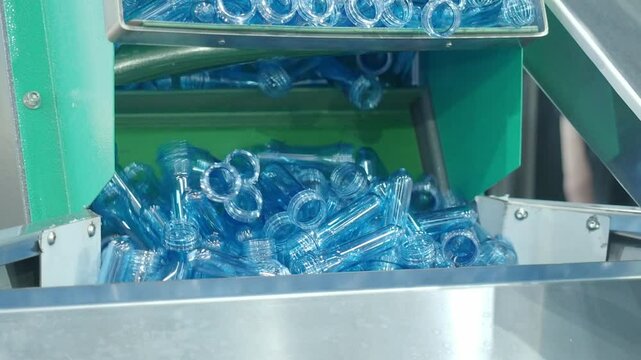 Demo making of PET or drinking water plastic bottle such as PET preform before automate heat blowing and shaping in molding machine and other process of making plastic bottles. Drinking water industry