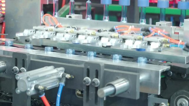 Demo making of PET or drinking water plastic bottle such as PET preform before automate heat blowing and shaping in molding machine and other process of making plastic bottles. Drinking water industry