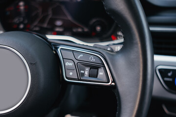 Obraz premium Modern brown car interior, leather steering wheel, climate control, navigation, air ducts, deflectors on the car panel, interior details.
