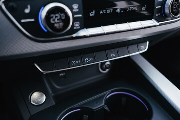 Fototapeta premium Modern brown car interior, leather steering wheel, climate control, navigation, air ducts, deflectors on the car panel, interior details.