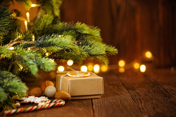 Christmas and zero waste, eco friendly packaging gift on wooden background under christmas tree. Eco christmas holiday concept. Sustainable christmas