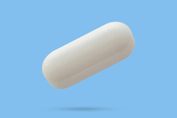 White medicine pill tablet float on blue background