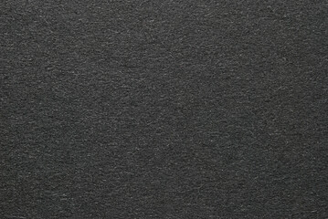 A sheet of black cardboard texture as background