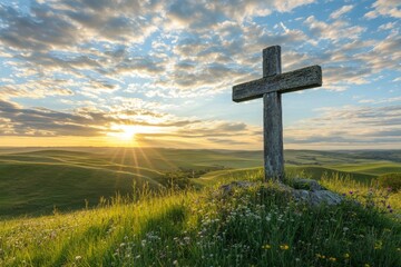 A wooden cross on the top of a hill.