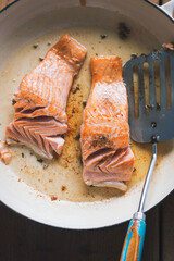 Salmon fried in oil on pan 