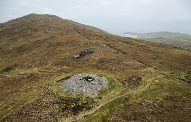Dun Bharpa prehistoric Neolithic chambered cairn with peristalith stone ring at Borve, Barra, Outer Hebrides. Looking NW to Allasdale