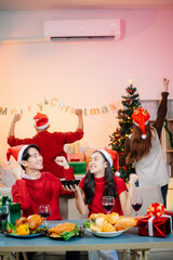 Enjoy the holiday spirit with a joyful Christmas celebration featuring friends, festive food, Santa hats,