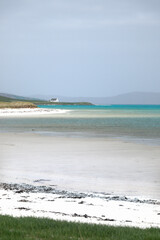 Traigh Mhor beach and cottage at Ardmore, Ardmhor on the north end of Barra, Outer Hebrides, Scotland. Looking NE