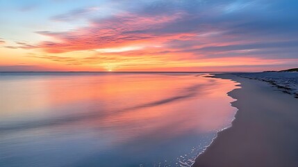 Fototapeta premium Serene Beach Sunset with Vibrant Sky. Perfect for themes of relaxation, nature, and tranquility.