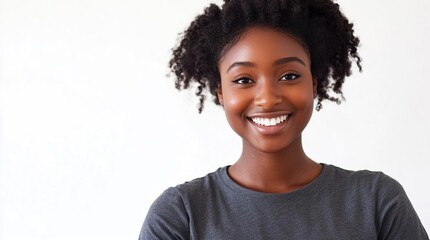 Portrait of a smiling young woman in casual attire against a white background
