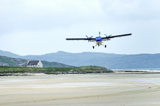 Barra Airport on Traigh Mhor beach at Ardmhor on north end of Barra, Outer Hebrides. Looking NE. Scheduled flight taking off from sands