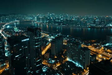 Obraz premium Night cityscape, illuminated buildings, city lights, river reflection.