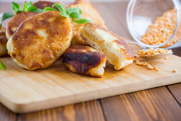 cooked fried pea pies on a wooden board