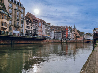 Fototapeta premium Strasbourg, Ill River canal with promenade and row of colorfultownhouses, France, Bas-Rhin, 