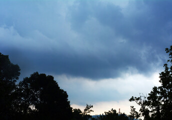 the sky before the heavy rain poured down on the surface of the earth, the blue color slowly clotted to black