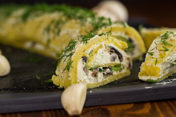 baked potato roll with cottage cheese filling with garlic and mushrooms, on a dark wooden table