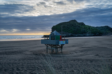 Lifeguard station at the Te Henga surf beach captured at sunset, Auckland, New Zealand