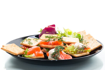 small snack canapes with crackers and lightly salted red fish Salmon, isolated on white background