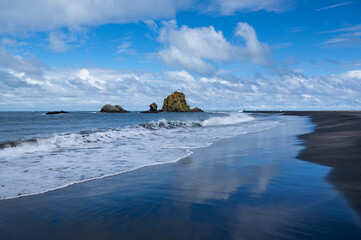 Clouds reflections at Auckland’s West Coast Whatipu Beach, New Zealand
