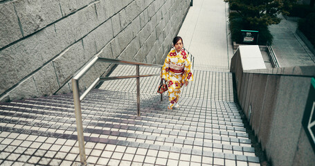 City, walking and woman on stairs with kimono, morning commute and sightseeing in traditional...